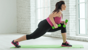 Girl performs exercise with weights
